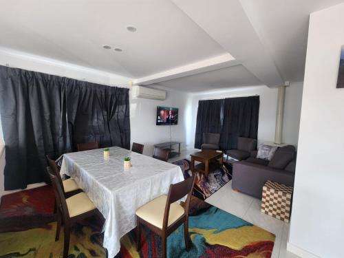 a living room with a table and a couch at Crest Motor Inn in Queanbeyan
