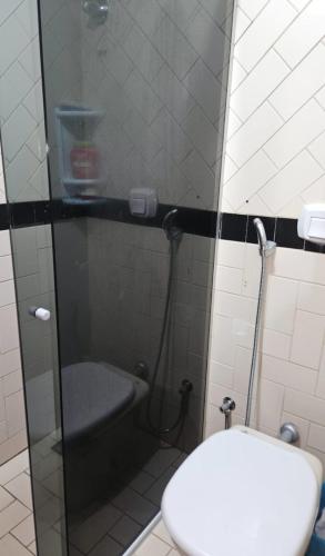a bathroom with a shower with a toilet and a sink at Eldorado Flat Service in Caldas Novas