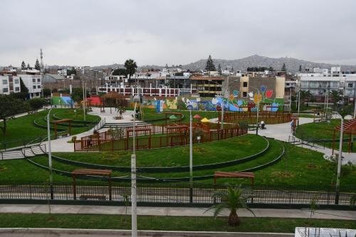 a park with benches and buildings in a city at B&B Villamar Chorrillos in San Antonio