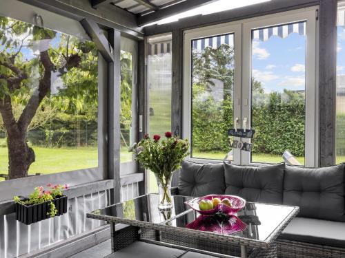 a screened in porch with a couch and a table at Nelson in Jabel