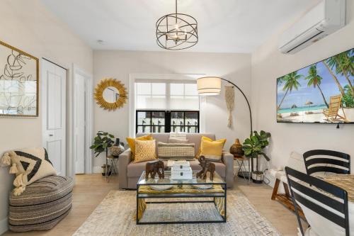 a living room with a couch and a table at Spanish Charm 4br Guest House Private Yard in West Palm Beach