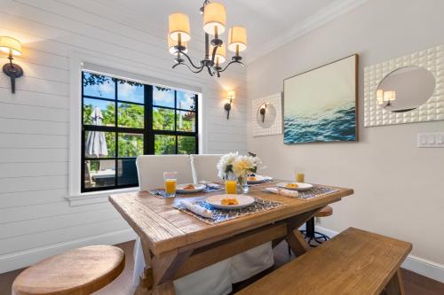 a dining room with a table and a window at Spanish Charm 4br Guest House Private Yard in West Palm Beach
