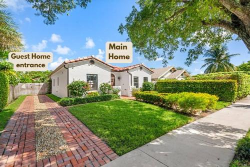 a house with a sign that reads main home at Spanish Charm 4br Guest House Private Yard in West Palm Beach