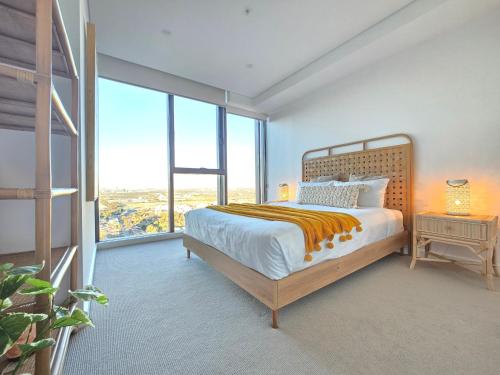a bedroom with a bed and a large window at Paramount Suite on Parkes Pool And City View in Sydney
