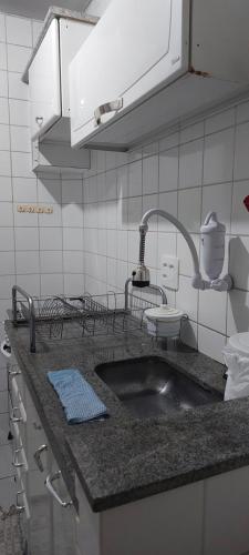 a kitchen counter with a sink in a kitchen at Quarto individual em apto aconchegante in Sao Jose do Rio Preto