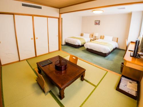 Ένα ή περισσότερα κρεβάτια σε δωμάτιο στο Hotel Rishiri
