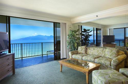 a living room with a couch and a television at Aston Kaanapali Shores in Lahaina