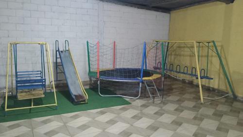 a gym with three slides and a trampoline at Sítio vida boa - Jambreiro in Itabira