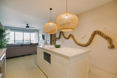 a living room with two lamps and a snake on the wall at Maritime Apartment Sea View in Huatulco, 2 Rec in Bahías de Huatulco