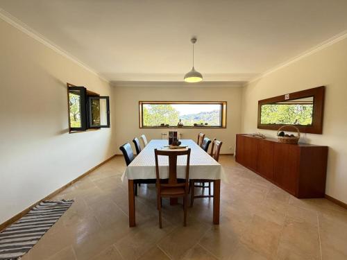 a dining room with a table and chairs at Casa Bagulho - Cabril, Gerês in Montalegre