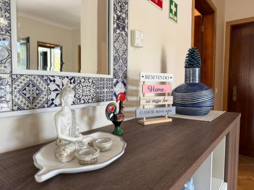 a counter with vases and other items on it at Casa Bagulho - Cabril, Gerês in Lapela