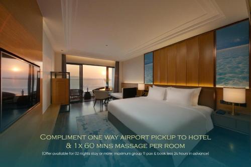 a hotel room with a large bed and a desk at Grand Hyams Hotel - Quy Nhon Beach in Quy Nhon
