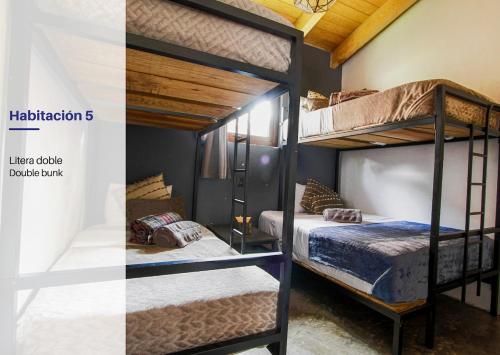 two bunk beds in a small room with at Spacious and Modern Cabin in Tapalpa, 5 Bedrooms in Tapalpa
