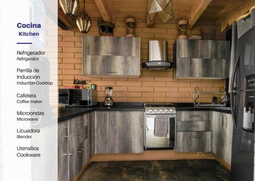 a kitchen with stainless steel cabinets and appliances at Spacious and Modern Cabin in Tapalpa, 5 Bedrooms in Tapalpa