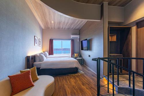 a hotel room with a bed and a balcony at TWIN LINE HOTEL YANBARU OKINAWA JAPAN Formerly Okinawa Suncoast Hotel in Nago