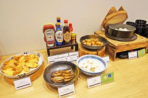 a table topped with bowls of food and bottles of beer at Chisun Grand Takayama in Takayama