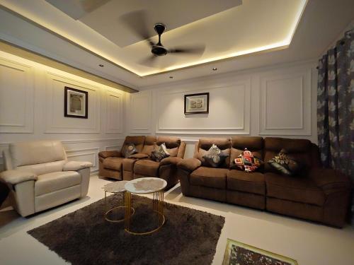 a living room with two couches and a table at AL-MANAL 203 Luxury Suite Rooms 3BHK in Bhatkal