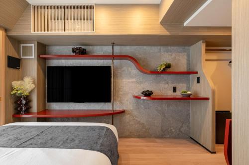 a bedroom with red shelves and a bed at ACROSS Akihabara in Tokyo