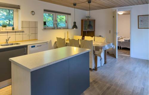a kitchen with a counter and a dining room at 2 Bedroom Cozy Home In Ebeltoft in Øksenmølle