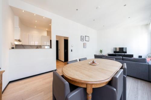 een woonkamer met een tafel en een bank bij A Marbled Touched Haven in Antwerpen