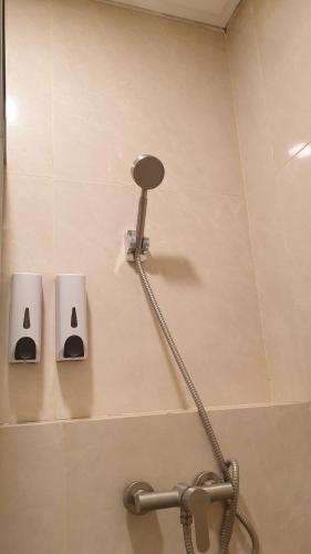 a bathroom with a shower with a shower head at Balconé Lodge in Bandung