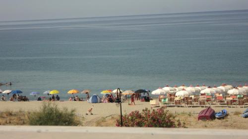 a group of people on a beach with umbrellas at Casa Vacanza Alice & Mari in Ascea