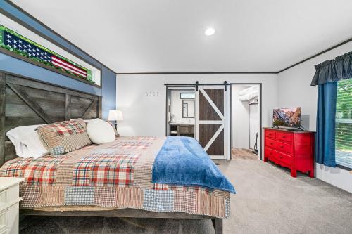 a bedroom with a bed and a red dresser at Bon Air Bungalow in Sparta