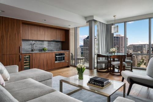 a living room with a couch and a table at The Ritz-Carlton Residences, Waikiki Beach Hotel in Honolulu