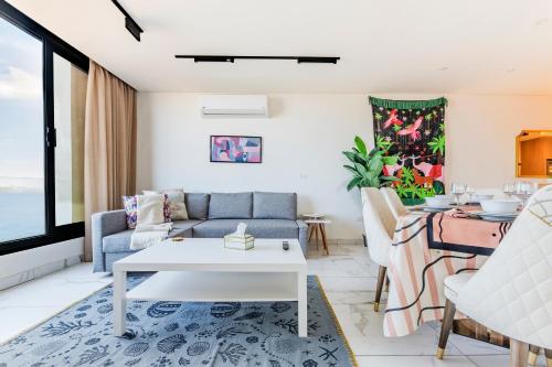 a living room with a couch and a table at Nabeel Homes - Seaview Building - 3 Units in Gleem in Alexandria