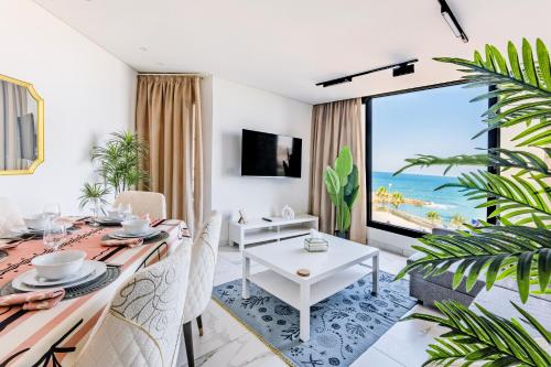 a dining room with a table and a view of the ocean at Nabeel Homes - Seaview Building - 3 Units in Gleem in Alexandria