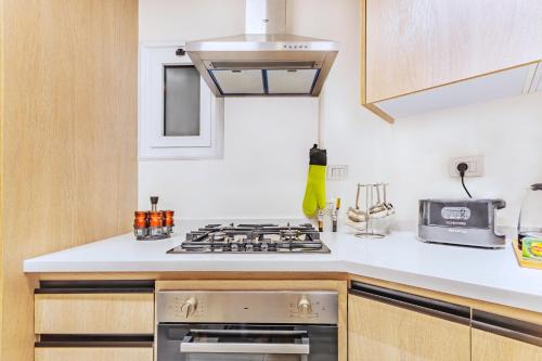a kitchen with a stove and a sink at Nabeel Homes - Seaview Building - 3 Units in Gleem in Alexandria