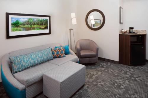 a living room with a couch and a chair at Courtyard by Marriott Houma in Houma