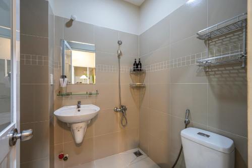 a bathroom with a toilet and a sink at Urban Stay District 3 in Ho Chi Minh City