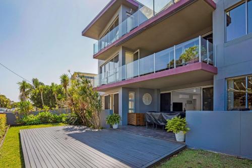 an exterior view of a house with a deck at Reflections G01 On The Lake in Forster
