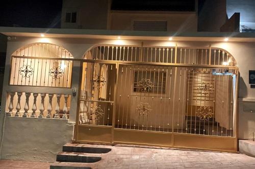 a gate to a house with lights on it at Complete house at North, Gate Control, We invoice in Ramos Arizpe