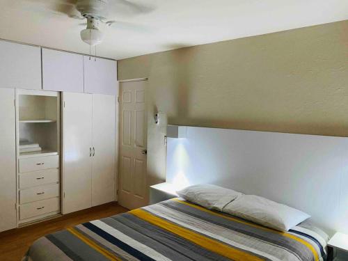 a bedroom with a bed and a white cabinet at Complete house at North, Gate Control, We invoice in Ramos Arizpe