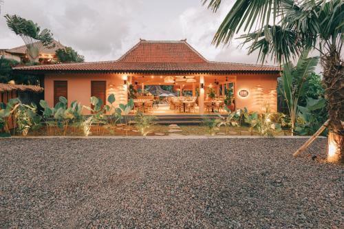 a house with a patio in front of it at Tebola Joglo Villas in Sidemen