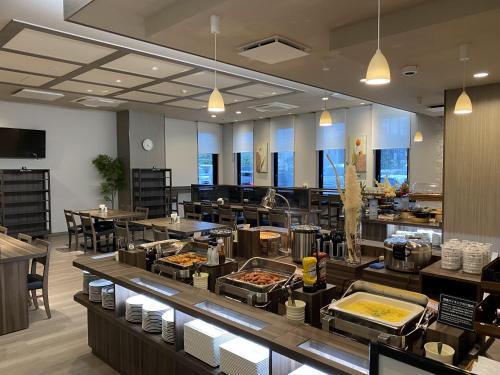 a restaurant with a buffet line with food at Hotel Route-Inn Noshiro in Noshiro