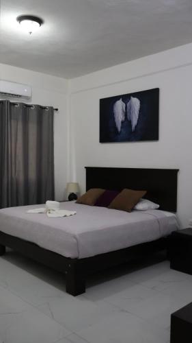 a bedroom with a large bed in a room at HOKAB in Cenote Azul