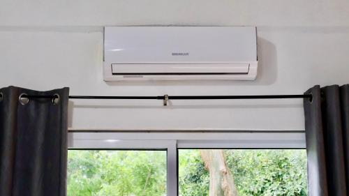 a air conditioner above a window in a room at HOKAB in Cenote Azul
