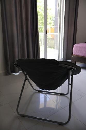 a black chair sitting in front of a window at HOKAB in Cenote Azul
