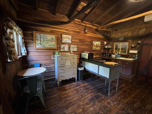 a kitchen with wooden walls and a table and a stove at The Renovated Barn at Seneca Rocks in Seneca Rocks