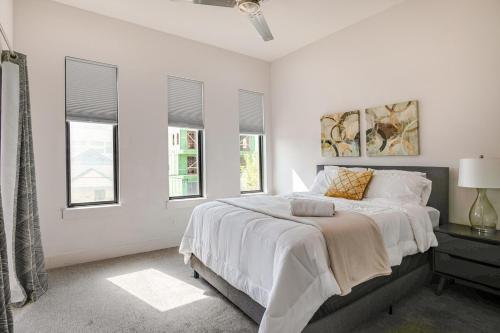 a white bedroom with a large bed and windows at Uptown Dallas Modern Retreat in Dallas