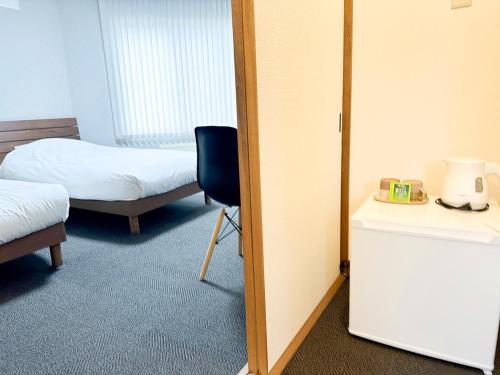 a room with a bedroom with a bed and a mirror at RONENAI BASE - Vacation STAY 87888v in Shibinai