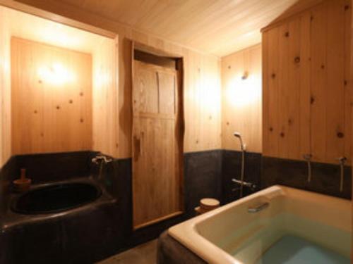 a bathroom with a bath tub and a sink at RONENAI BASE - Vacation STAY 87908v in Shibinai