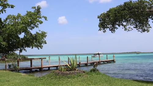 a row of wooden docks in the water at HOKAB in Cenote Azul