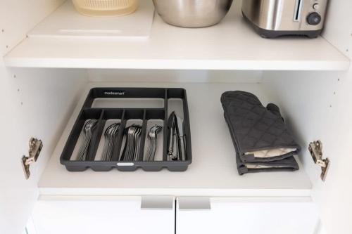 a drawer filled with utensils in a kitchen at Modern Lakefront Esc Stylish 2BR Condo with Patio in Toronto