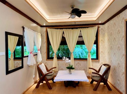 a dining room with a table and chairs and a window at Casa Rosa Inn and Restaurant in Taytay
