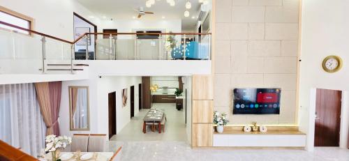a view of a living room with a tv in a house at CozyNest Luxury Smart Pool Villa in Lourdes