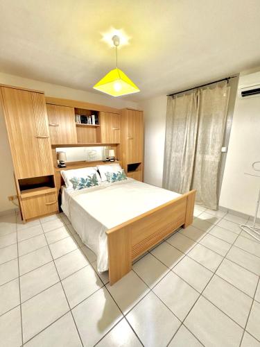 a bedroom with a large bed in a room at Le Nid du rocher in Le Diamant